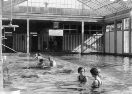 FDR receiving physical therapy or exercising with assistance in an indoor pool 