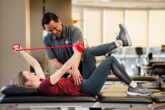Therapist helping a patient do pelvic floor exercises.